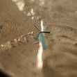 	An actual micro-windmill from UT-Arlington, held against a penny.