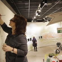 Monika Czerniec, left, art restoration expert, paints elaborate wall paintings that tell the story of Poland’s Jewish community at the new Museum of the History of Polish Jews in Warsaw, Poland, Monday, Feb. 17, 2014. The museum, largely paid for by Poland’s government, aims to reconstruct the climate of Jewish towns and synagogues through historical objects, multimedia, images, replicas, models and quotations from chronicles and diaries. On Monday, specialists were working on wall paintings representing small Jewish towns. (AP Photo/Czarek Sokolowski)