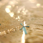 One of the micro-windmills is placed on a penny. Researchers in Texas envision embedding hundreds of them in a smartphone sleeve to provide a charge with the wind. Photo credit: University of Texas at Arlington