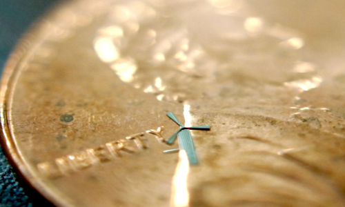 One of the micro-windmills is placed on a penny. Researchers in Texas envision embedding hundreds of them in a smartphone sleeve to provide a charge with the wind. Photo credit: University of Texas at Arlington