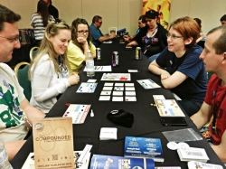Photo of people playing the chemistry-based board game Compounded. Photo of people playing the chemistry-based board game Compounded.